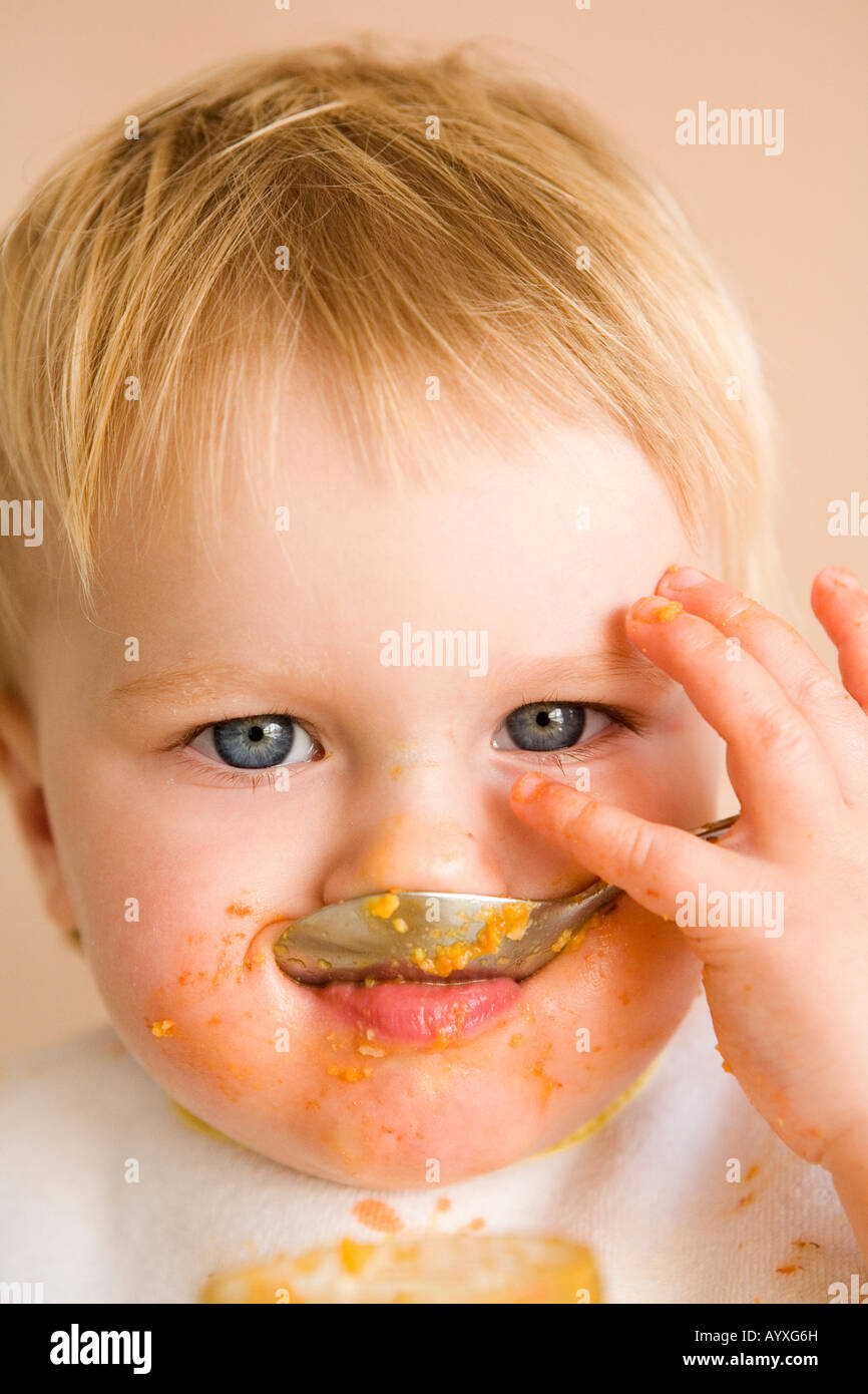 Portrait of toddler eating Stock Photo Alamy