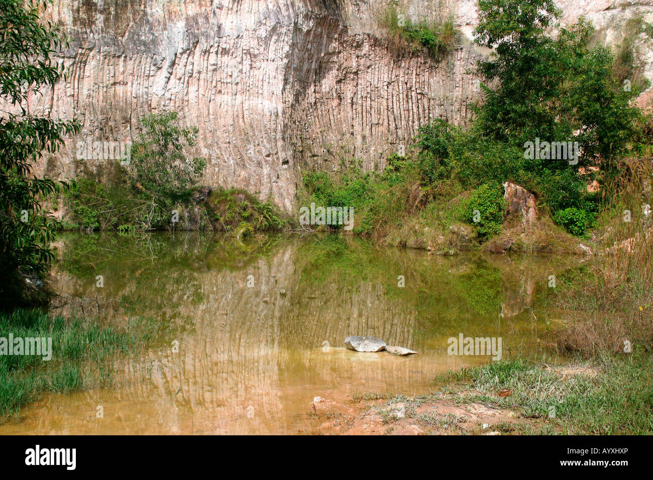 Reflections on the water - cliff-face reflected on the surface of a quarry pool Stock Photo