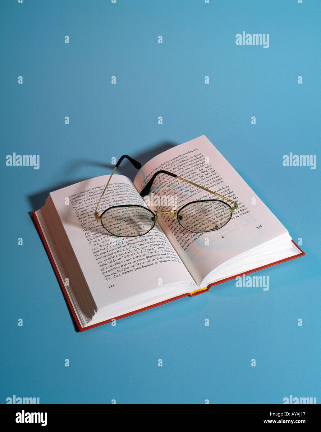 opened book, pair of spectacles Stock Photo