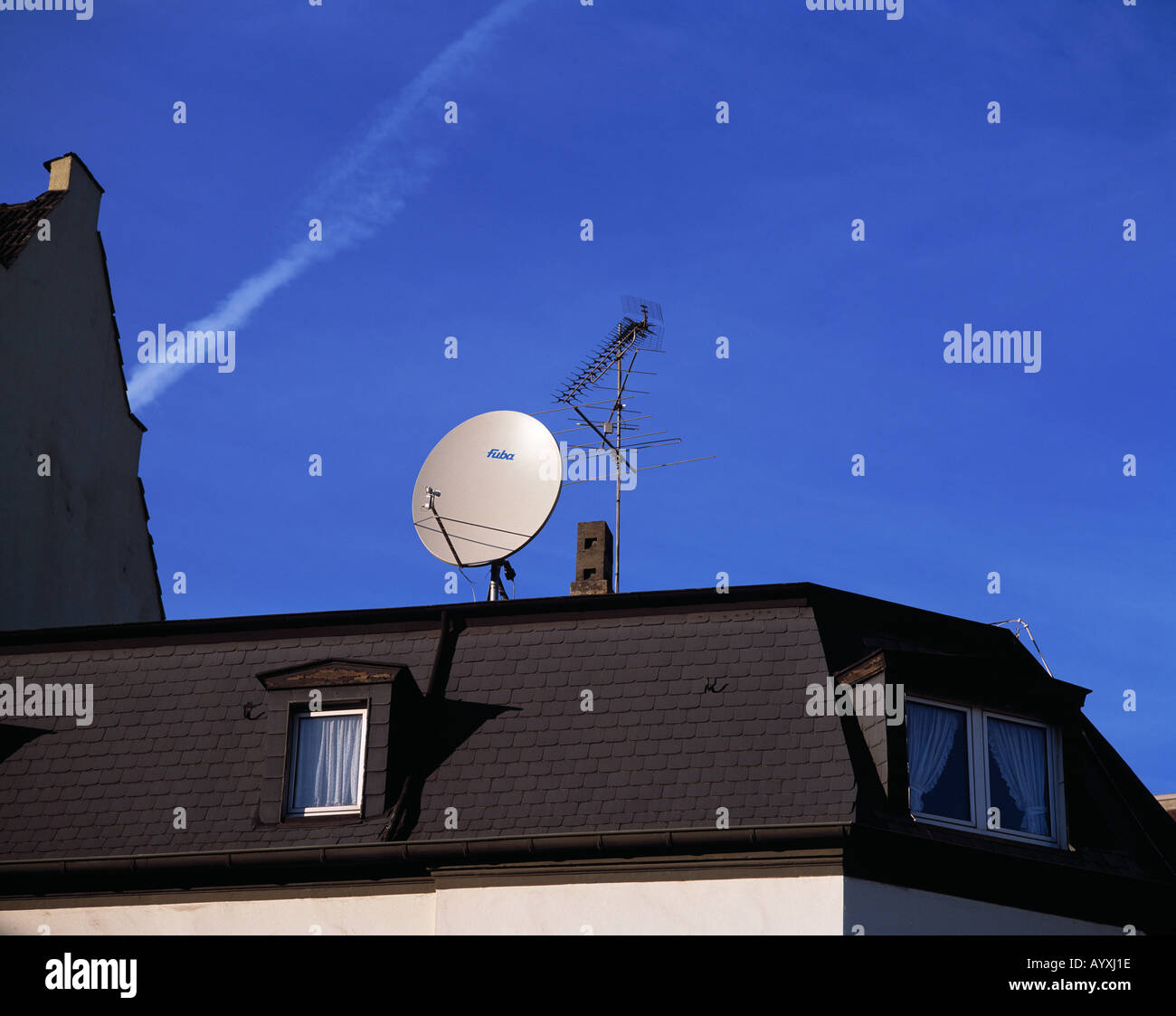 parabolic antenna and customary antenna on a house roof, digital and