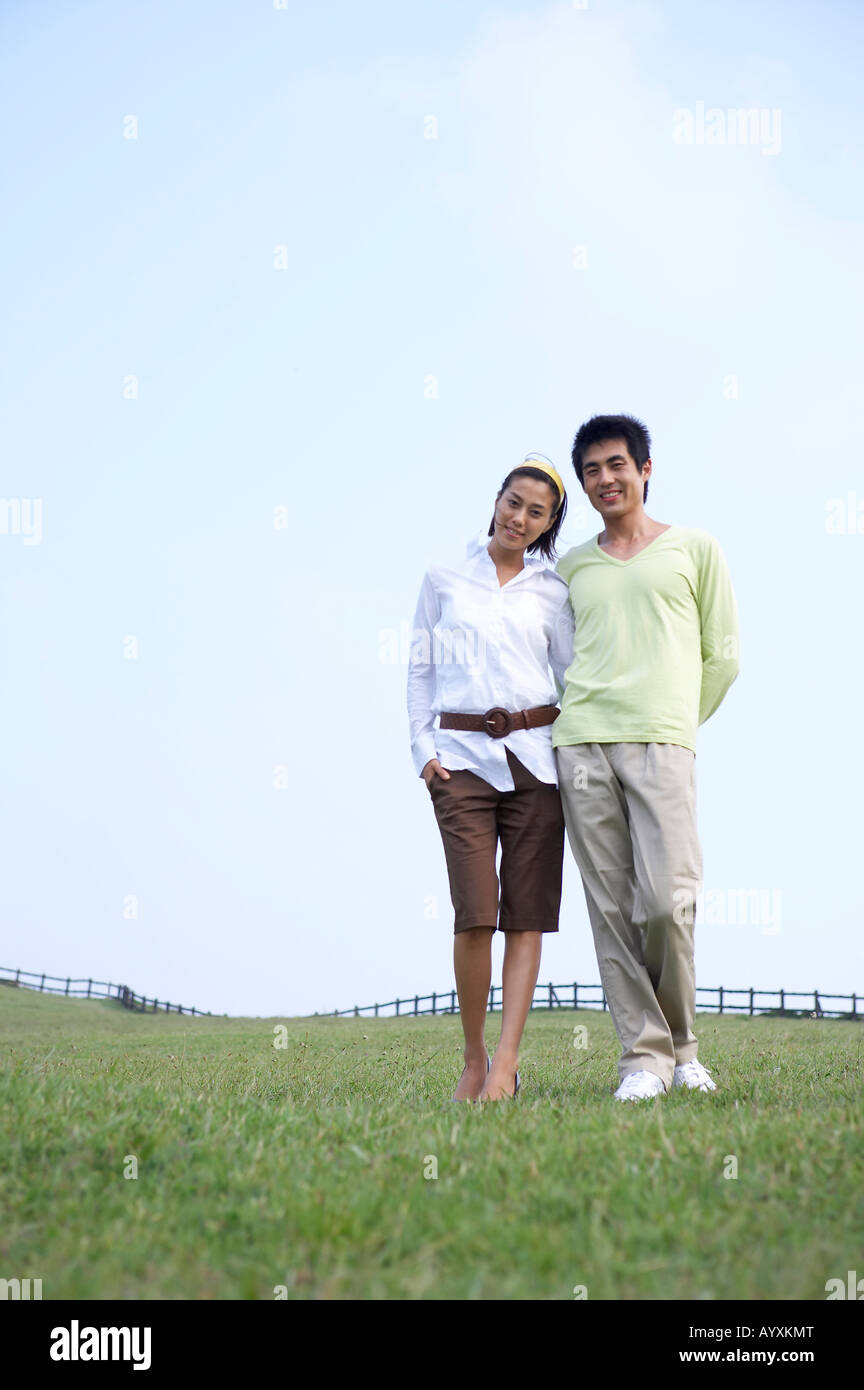 a couple walking in the grass field Stock Photo - Alamy