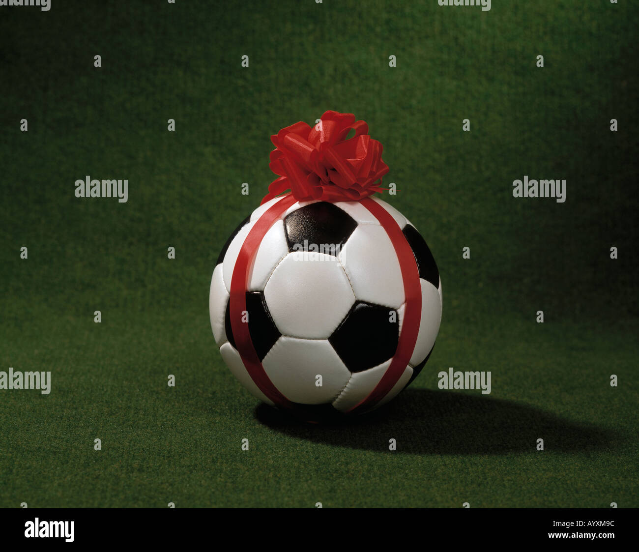sports, football, ball with a red skip-knot, symbolic photograph Stock Photo