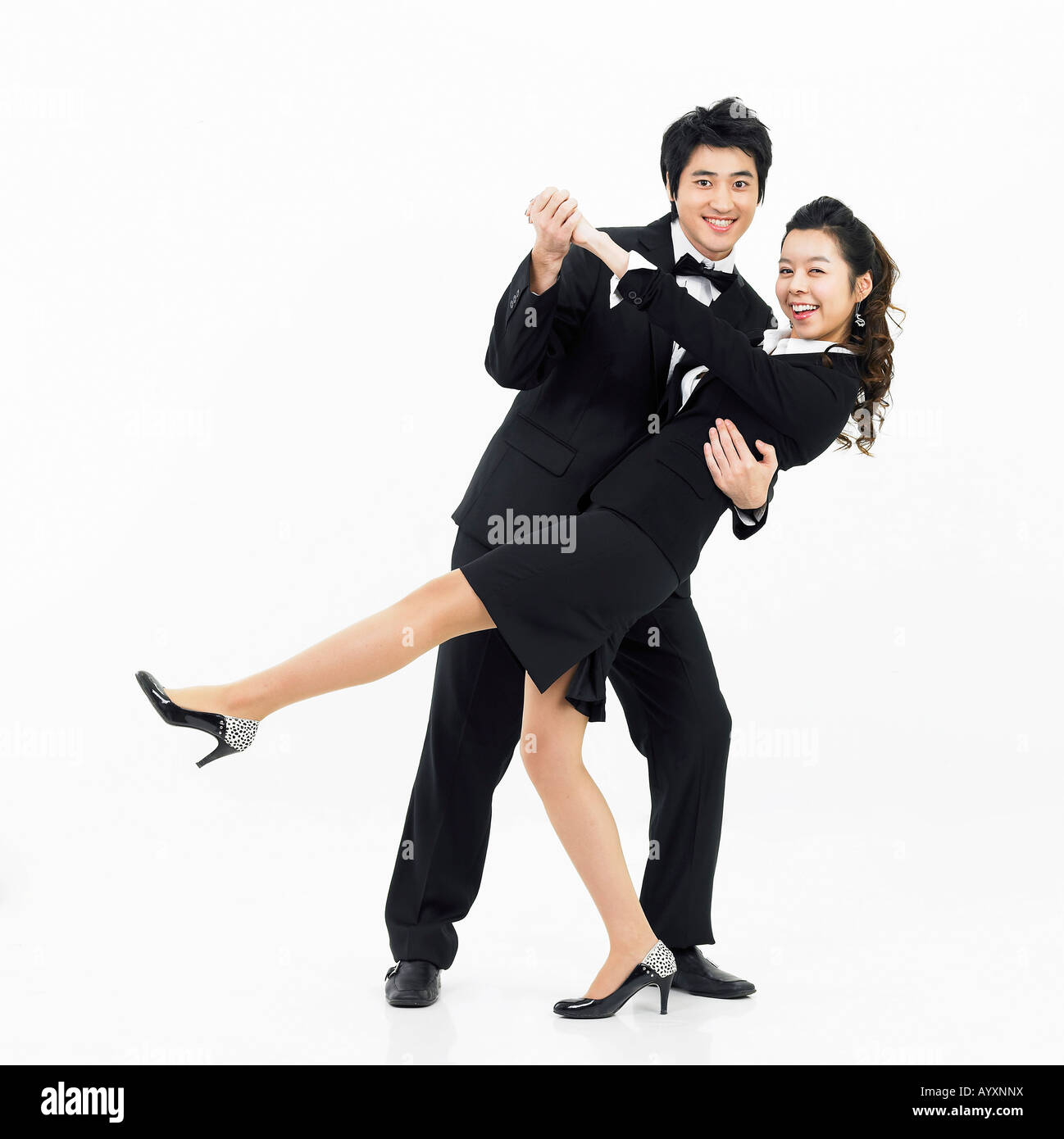 a couple in black suit dancing together Stock Photo Alamy