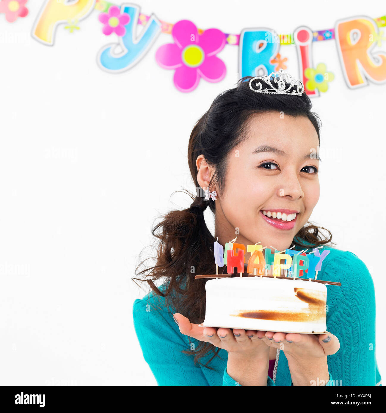 a smiling woman holding a birthday cake Stock Photo - Alamy
