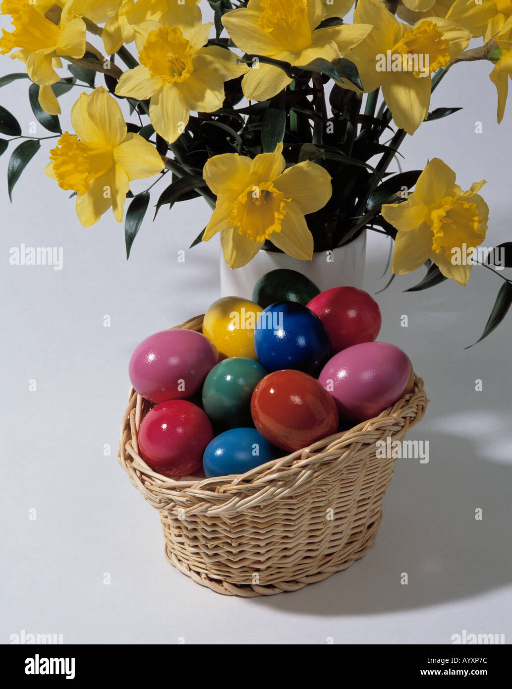 Easter, daffodils, narcissuses, basket with coloured eggs, Easter eggs Stock Photo Alamy