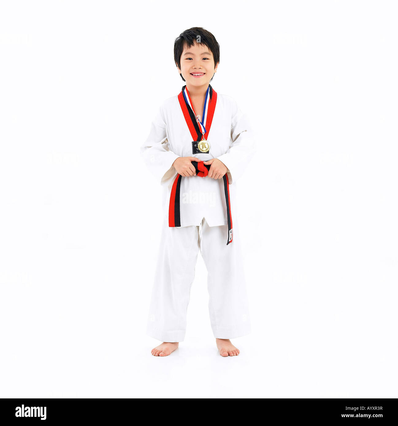 boy with medal on wearing taekwondo uniform Stock Photo