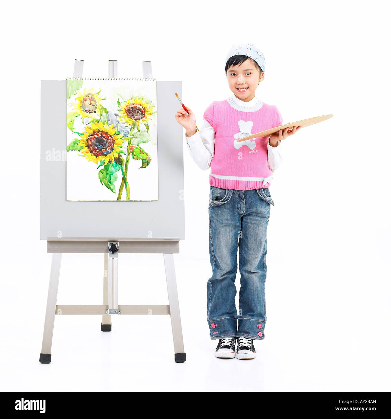 girl drawing a picture in front of easel Stock Photo - Alamy