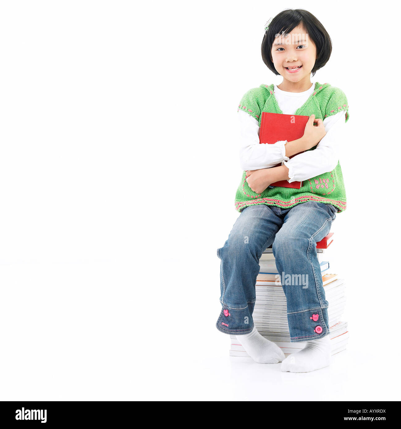 girl sitting on the stack of books Stock Photo - Alamy