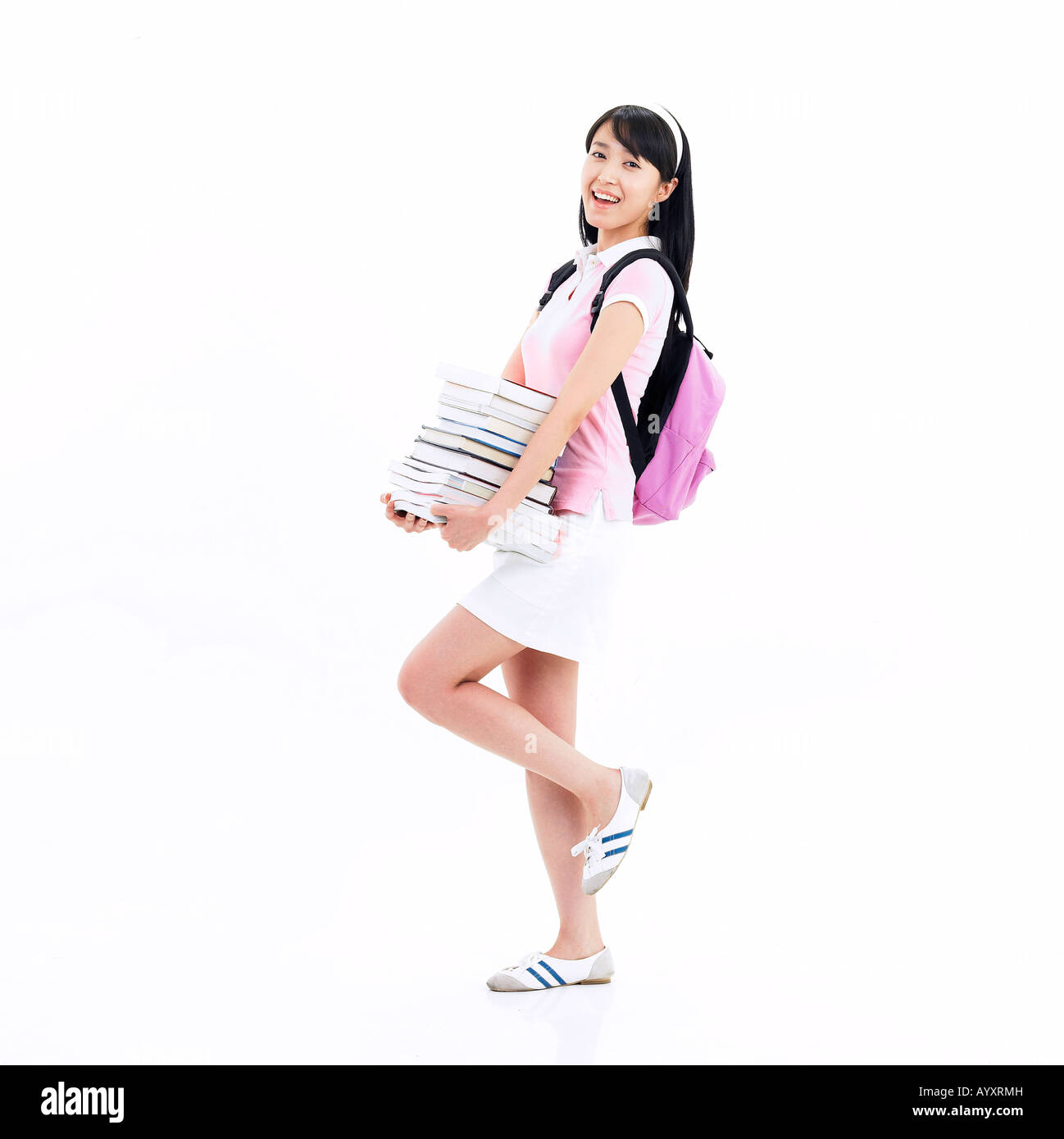 the girl standing with holding a full of books Stock Photo - Alamy