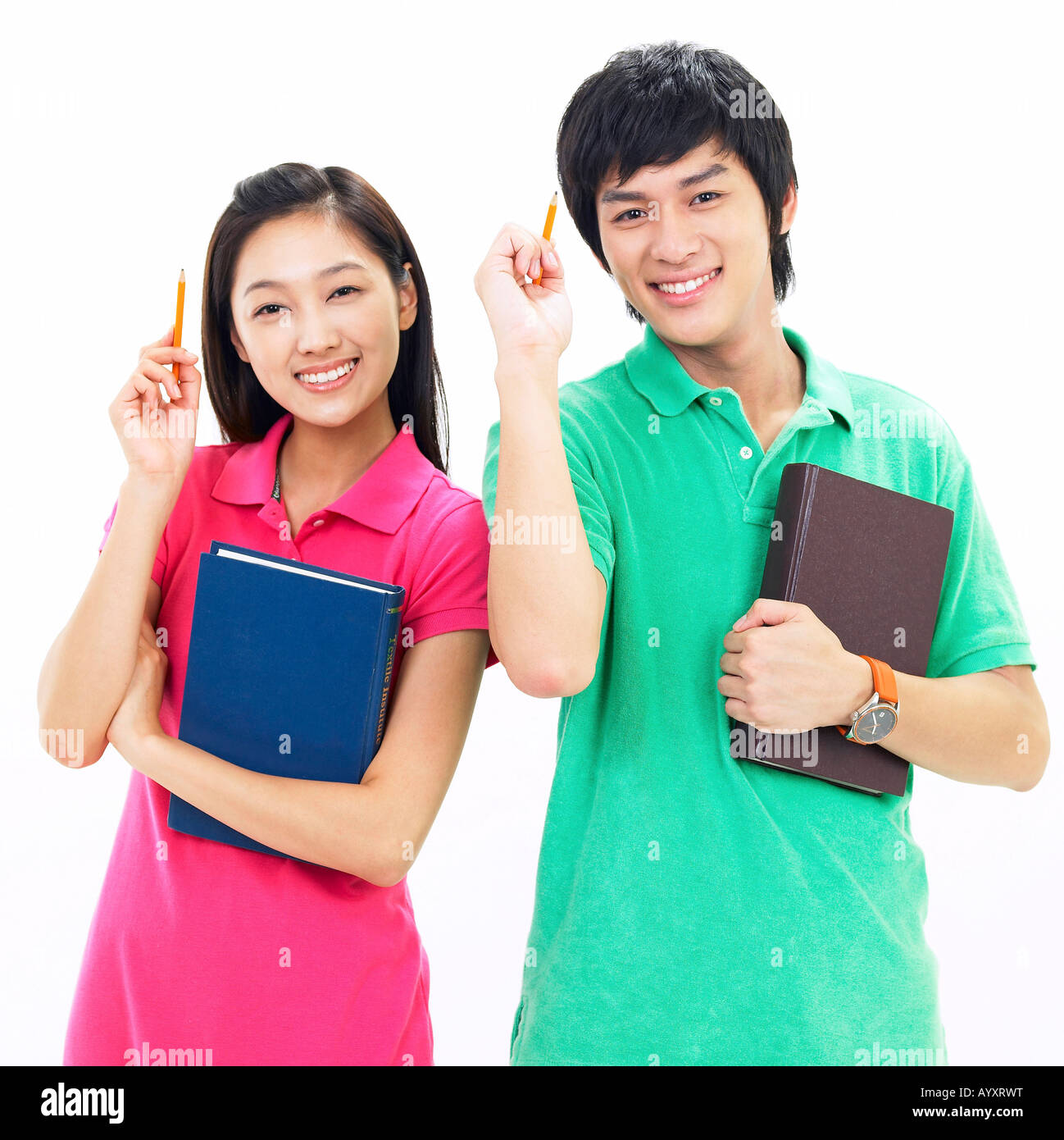 students smiling with holding a book and pencil Stock Photo - Alamy