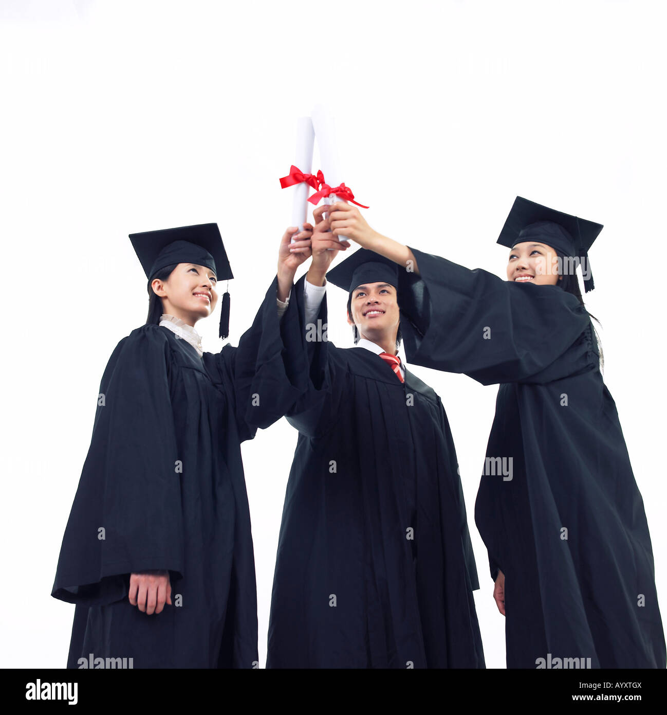 students wearing graduation cap and facing a diploma Stock Photo - Alamy