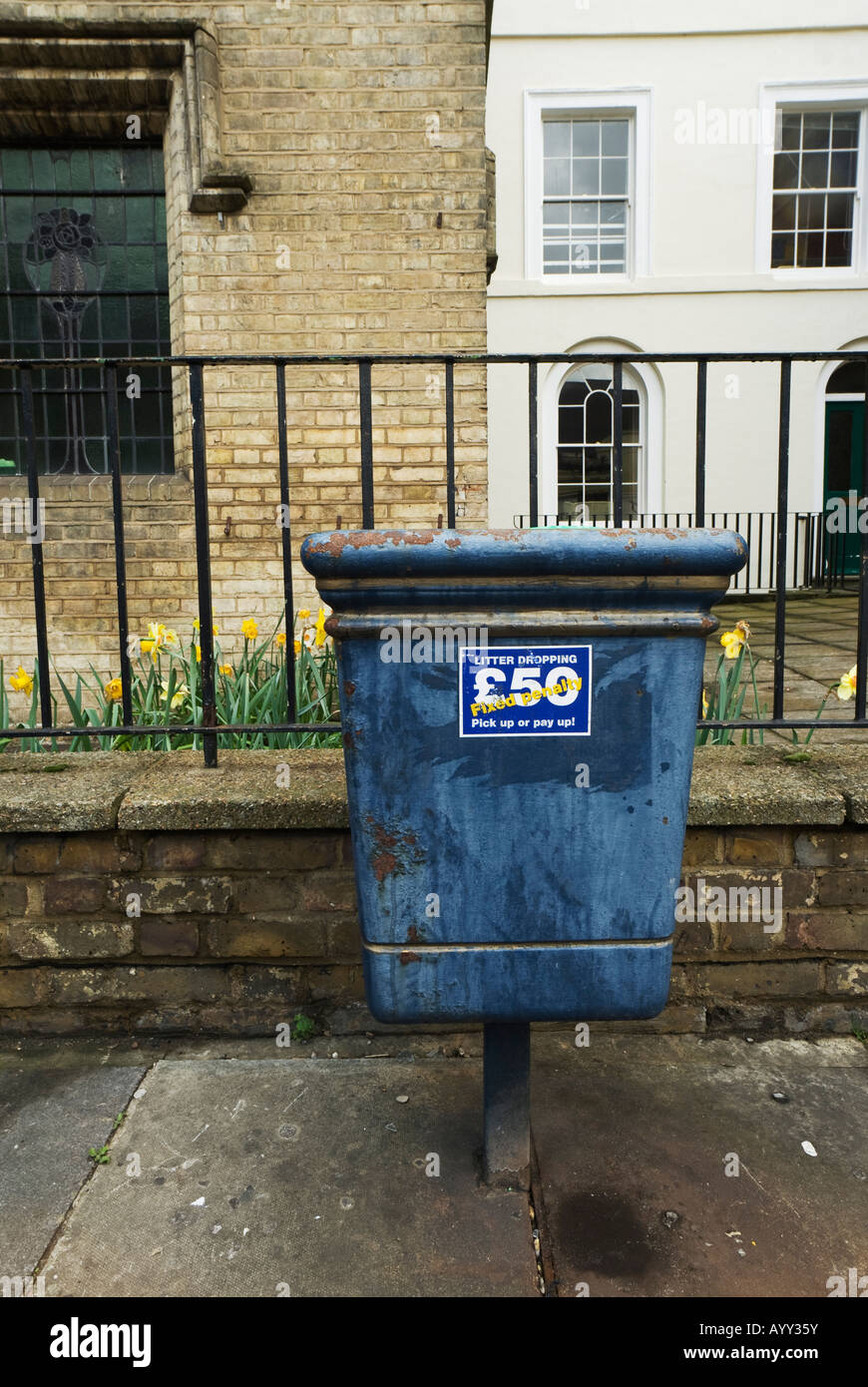 Rubbish bin with a penalty fine warning sticker hires stock