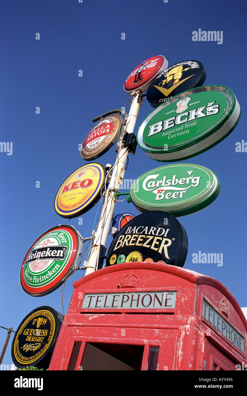 Alcohol advertisements next to a British telephone box in Limassol in South Cyprus Stock Photo