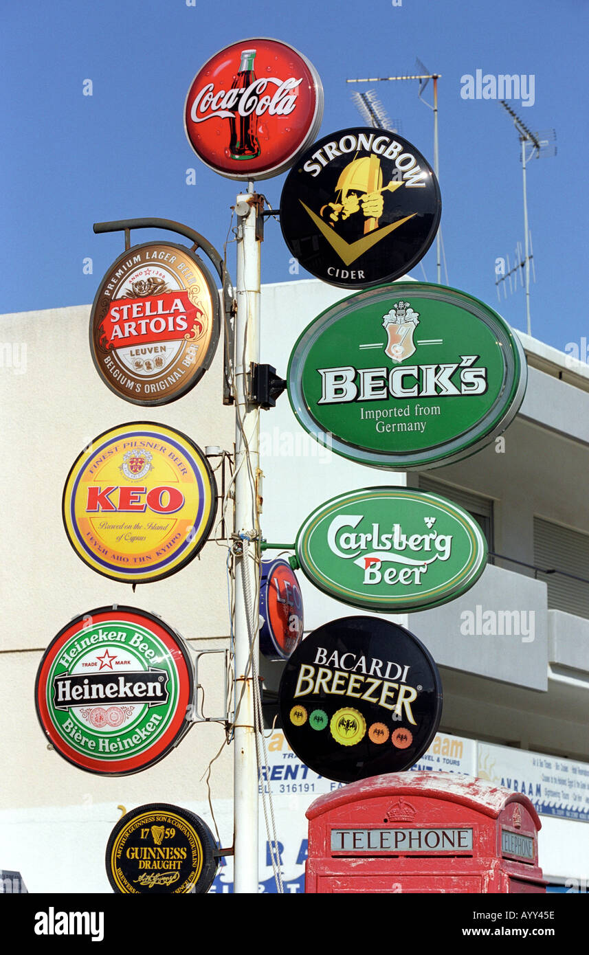 Alcohol advertisements next to a British telephone box in Limassol in South Cyprus Stock Photo