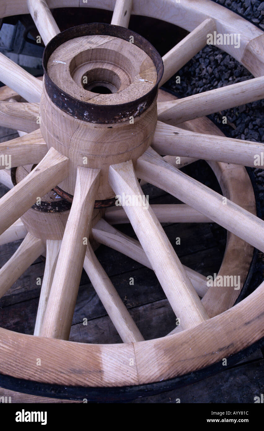 Traditional wheelwrights wooden wheels with its spokes and metal rim Stock Photo