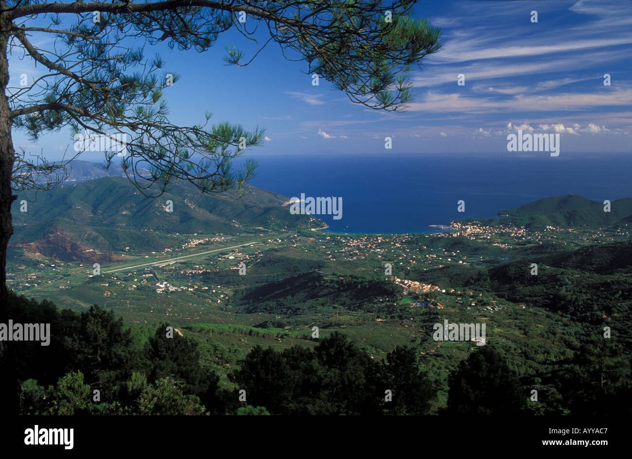 View over Gulf or Golfo di Campo with town Marina di Campo and airstrip La Pila Pine tree island Elba Italy Stock Photo