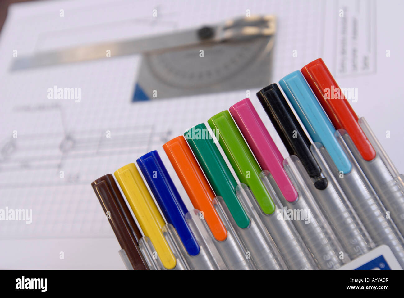 Close-up of coloured draughting pens with engineers' technical drawings Stock Photo