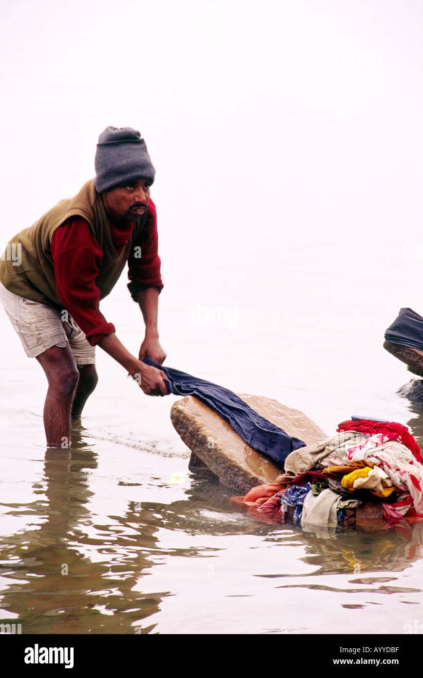 https://c8.alamy.com/comp/AYYDBF/one-indian-man-washing-laundry-on-a-large-flat-stone-standing-in-the-AYYDBF.jpg