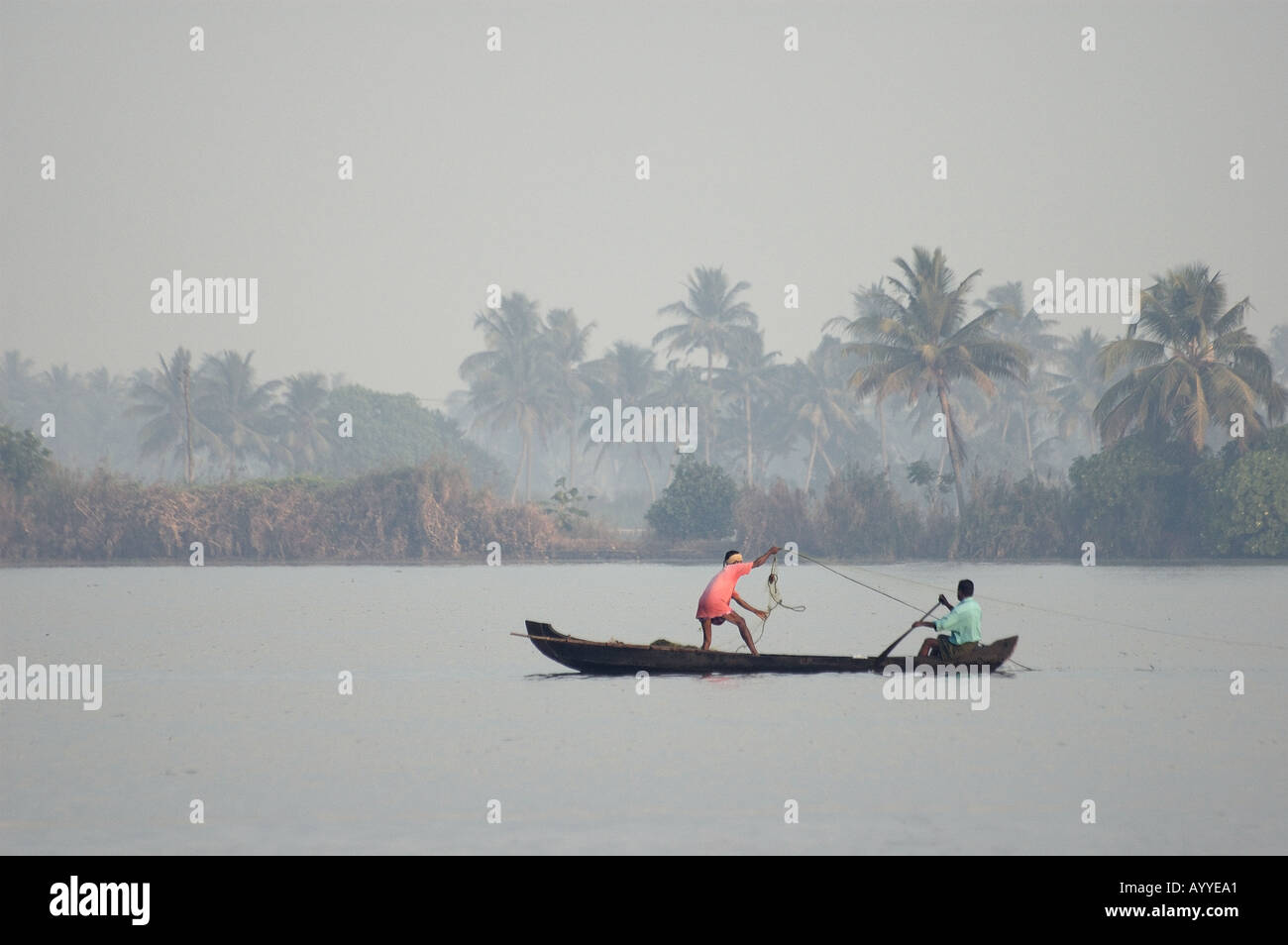 Fishing with nets on the backwaters Allepey Kerala South India Stock Photo