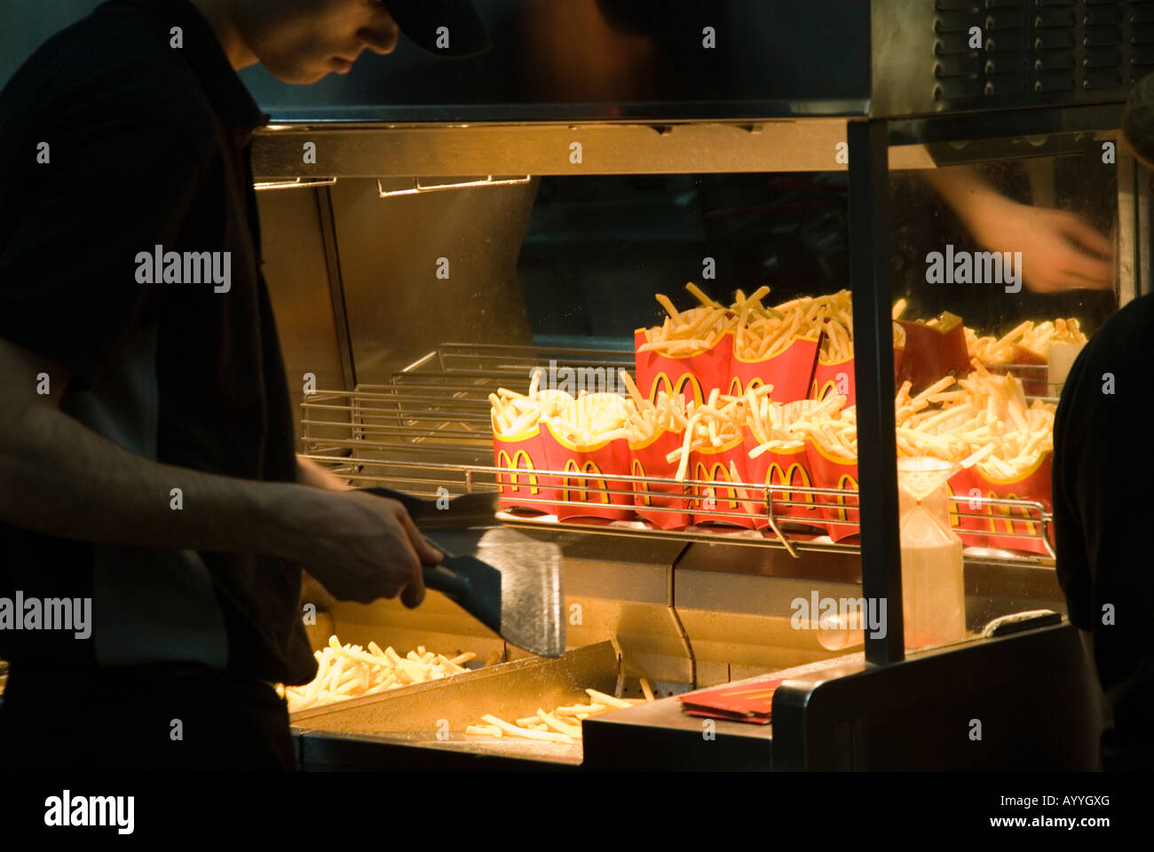 McDonald's worker making French fries England UK Stock Photo