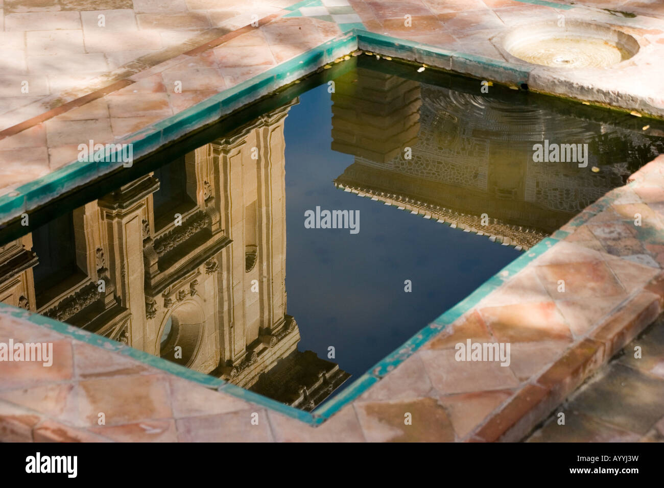A reflection of the Carlos V Palace in a pool at the Alhambra fortress ...