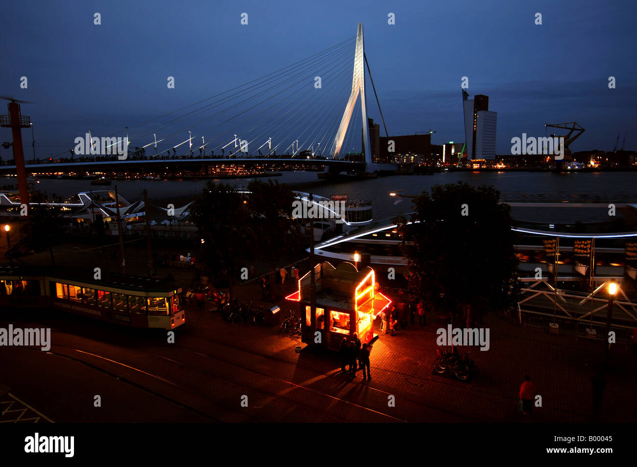Port of Rotterdam the Erasmus bridge kop van zuid the tramways and quays illuminated at night Stock Photo