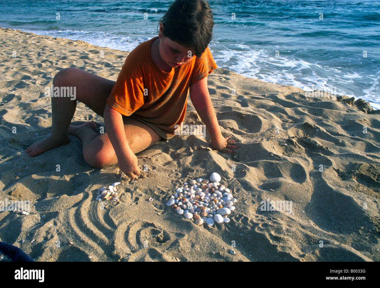Girl playing with shells hi-res stock photography and images - Alamy