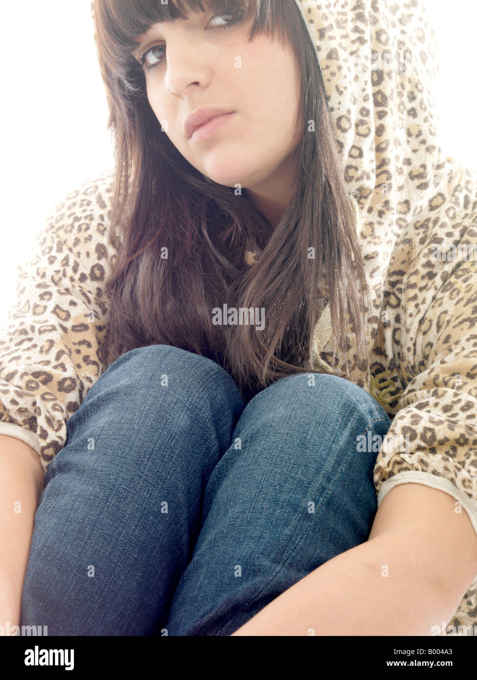 Young Depressed Teenage Girl Or Woman With Negative Thoughts Sitting Alone Needing Help With Mental Health Issues And Depression Stock Photo