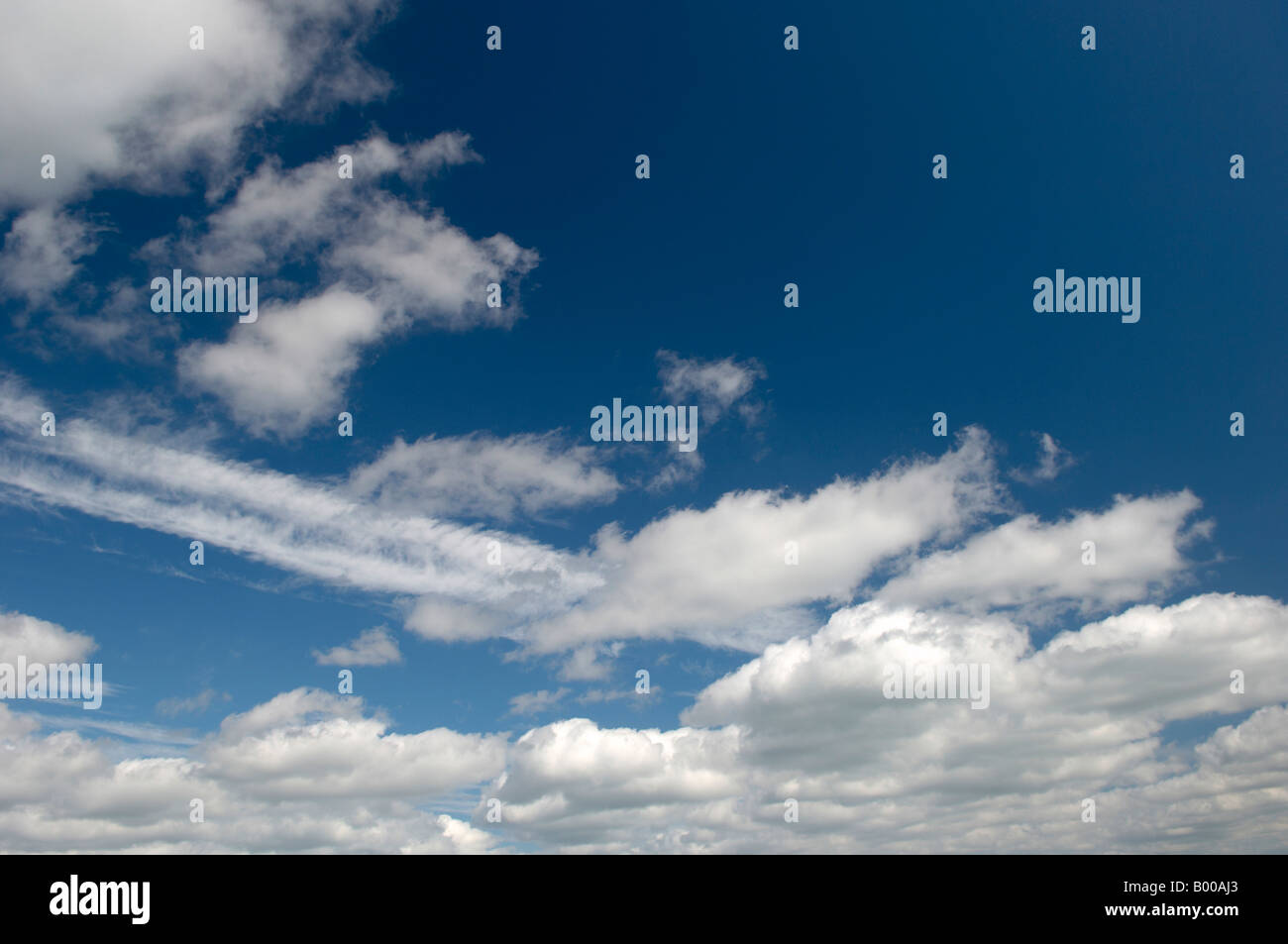 Blue sky with white fluffy clouds Stock Photo - Alamy
