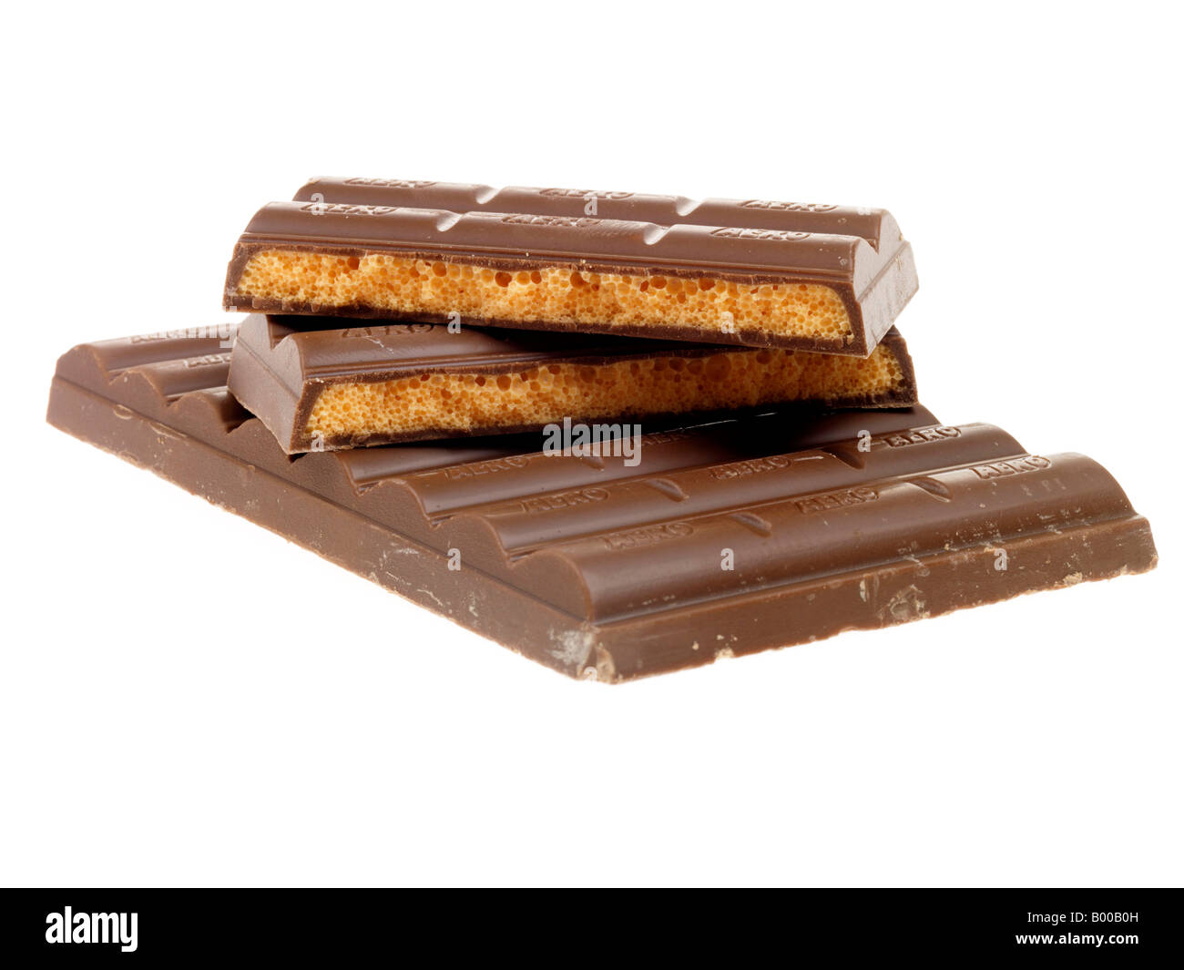 Stack Or Pile Of Orange Chocolate Aero Confectionery Or Sweets Against A White Background With Copy Space Or A Clipping Path With No People Stock Photo