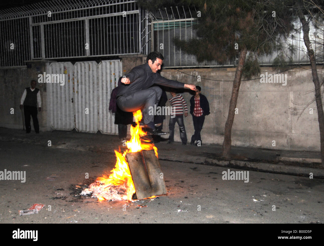 Iranian people jumping over bonfires during the festival of fire prior to the Persian new year, iphoto taken in Tehran, Iran. Stock Photo