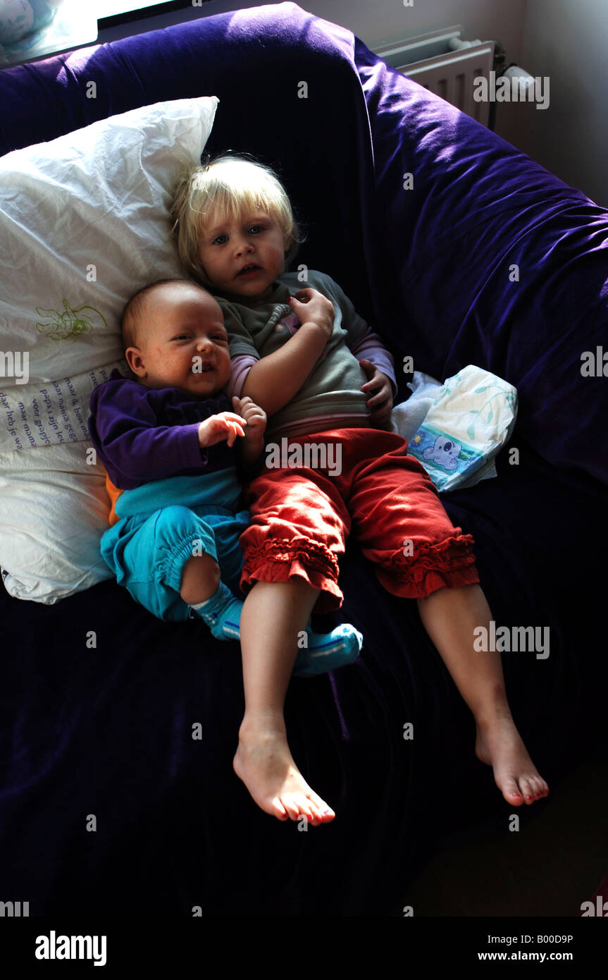 Brother and sister at home on the couch Stock Photo
