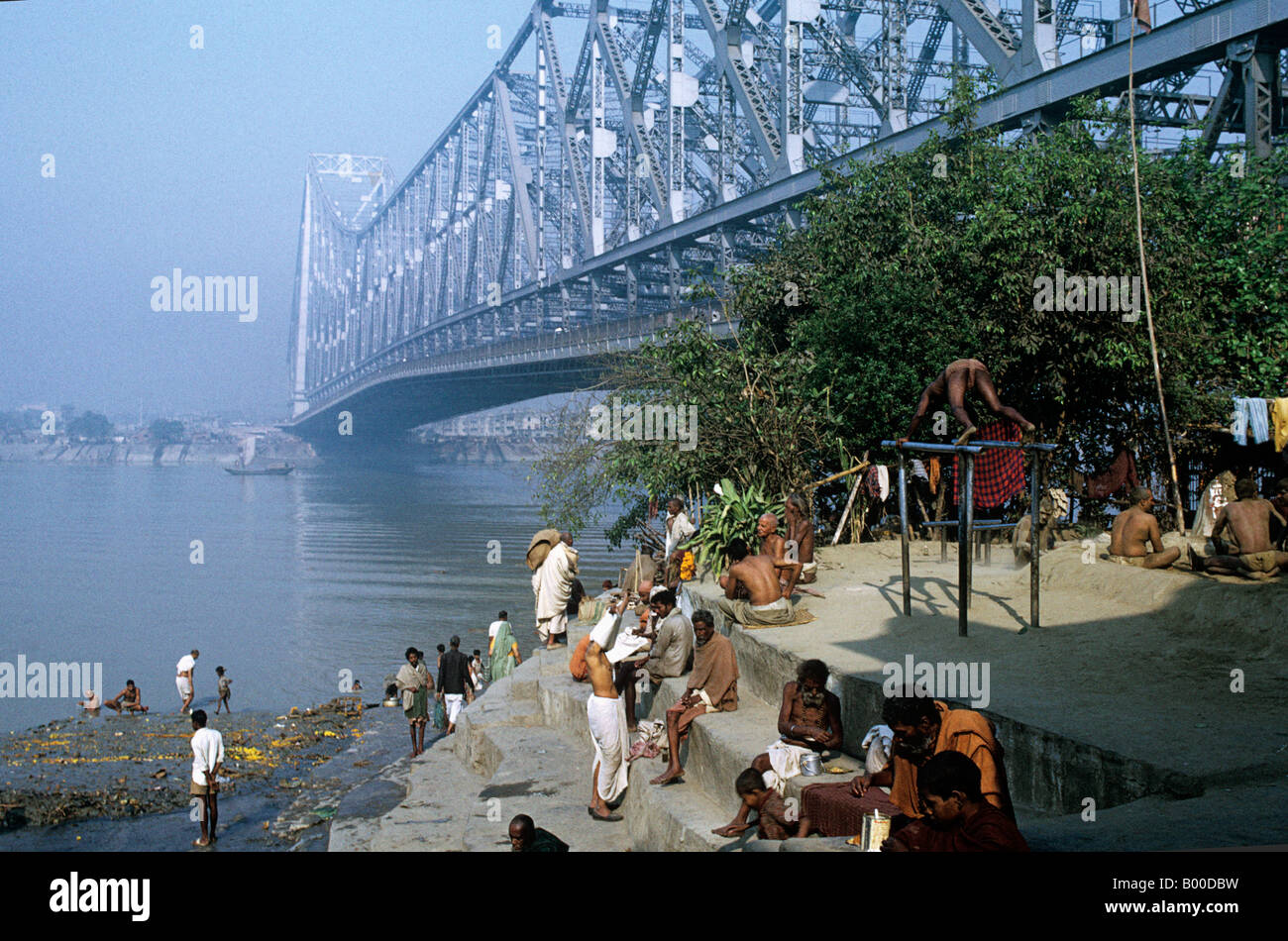 CalcuttaUnder Howrah Bridge bathing and early exercises on the parallel bars.(Kolkata)is noted for its revolutionary spirit Stock Photo