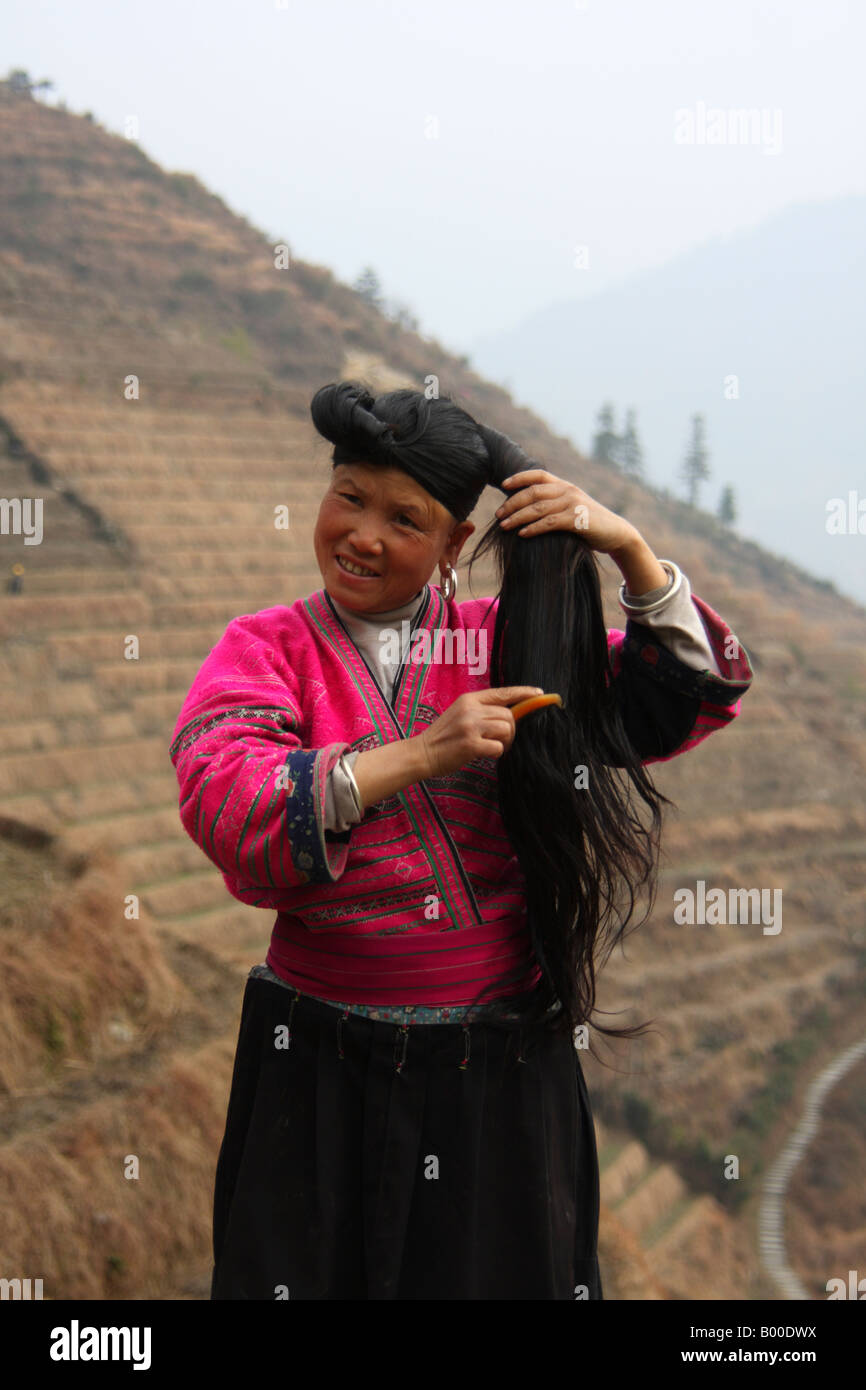 Yao woman with very long black hair demonstrates hair combing at Longji rice terraces, Pingan village, Longsheng County, China Stock Photo