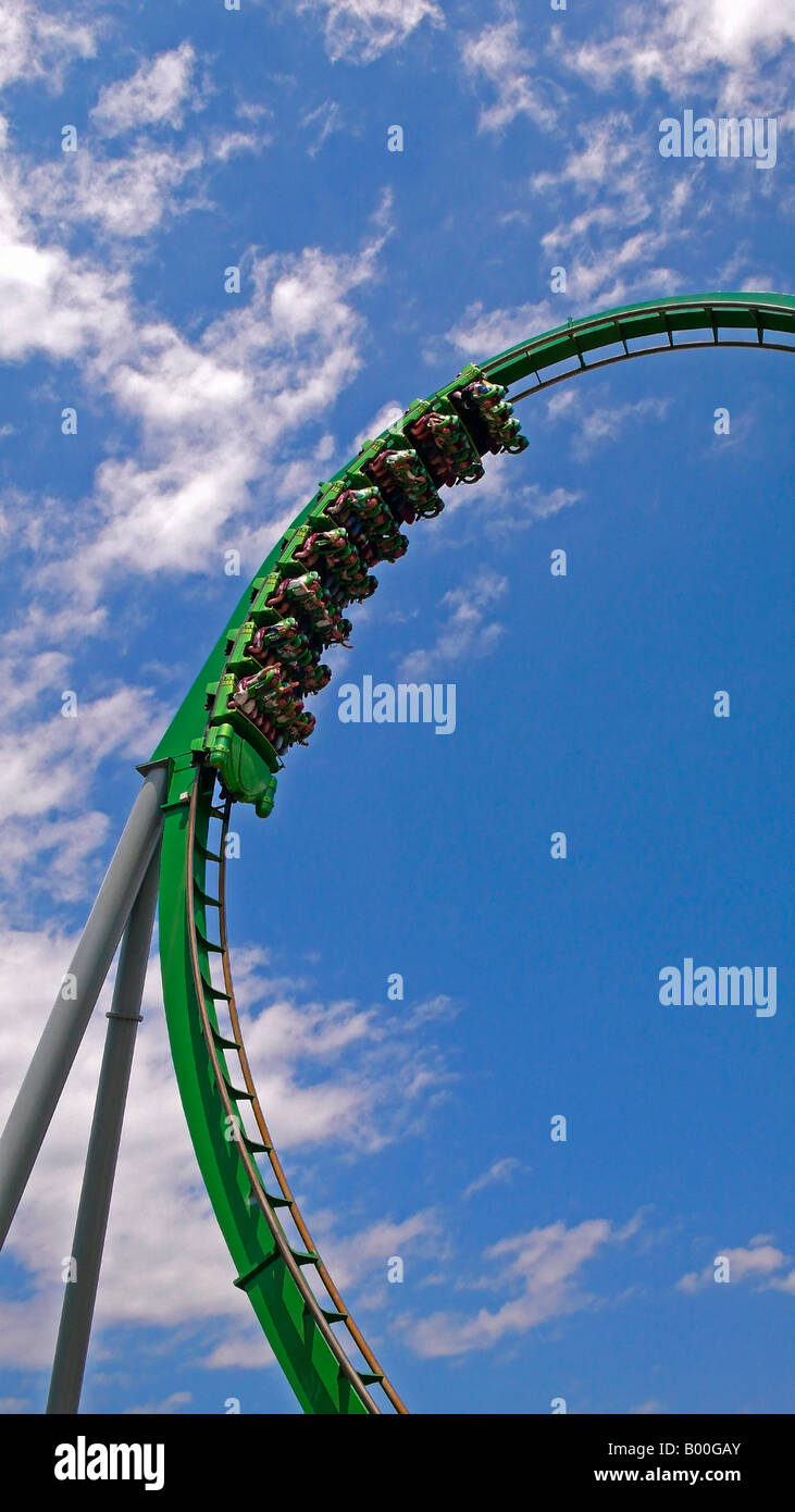 People on a green amusement park roller coaster ride Stock Photo - Alamy