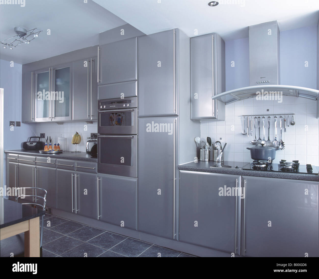 Wall Mounted Oven In Modern Metallic Grey Kitchen With Slate Floor