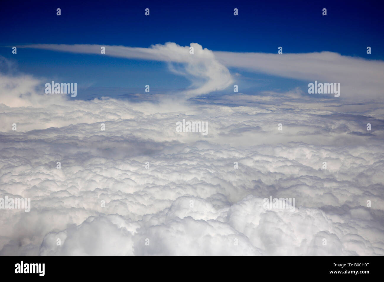 Nimbostratus clouds seen from an aeroplane in a deep blue polarised sky Stock Photo