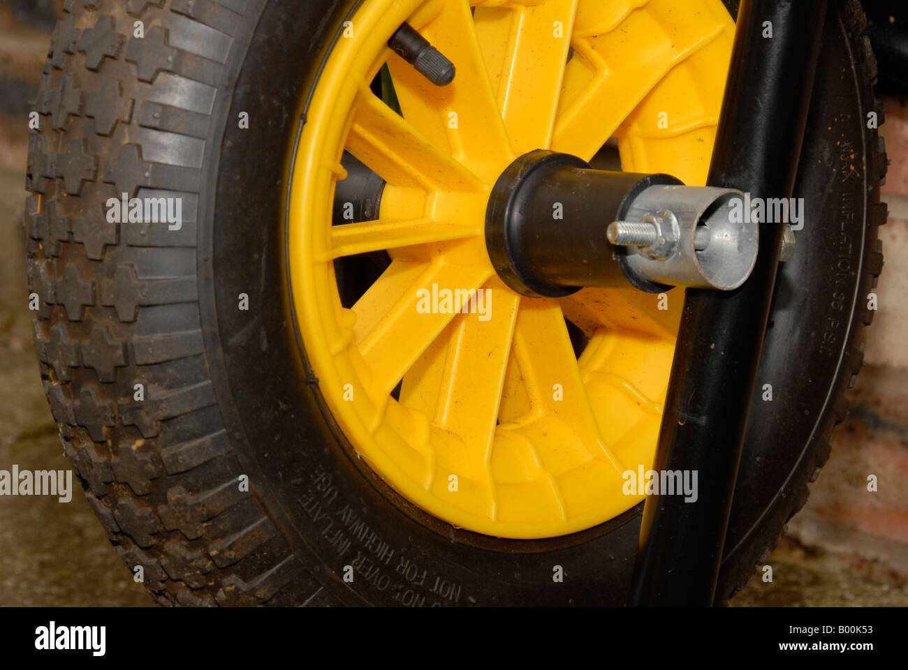 Bright yellow wheelbarrow wheel Stock Photo Alamy