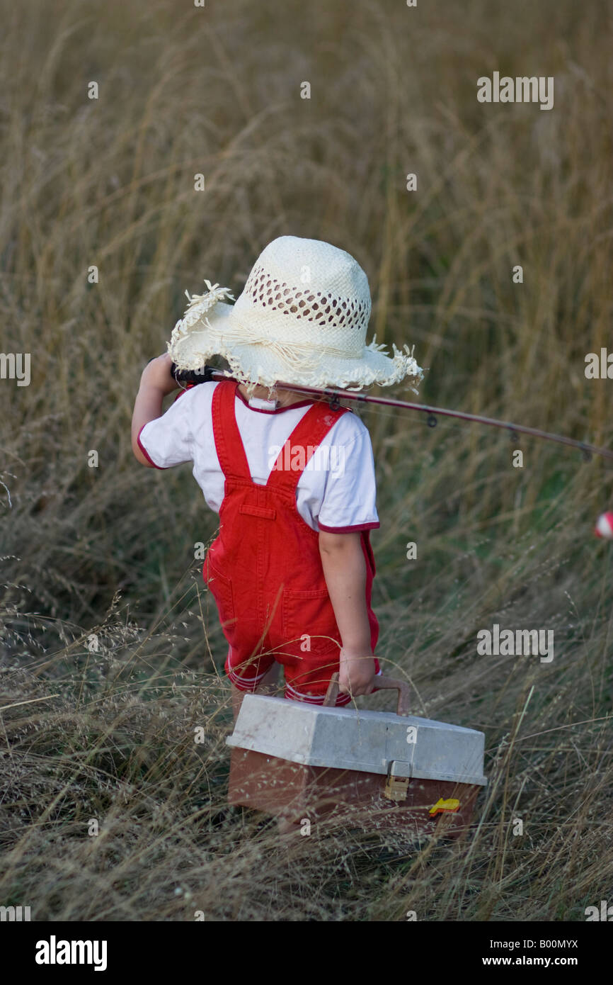Small girl carrying fishing pole and tackle box going fishing Stock Photo -  Alamy