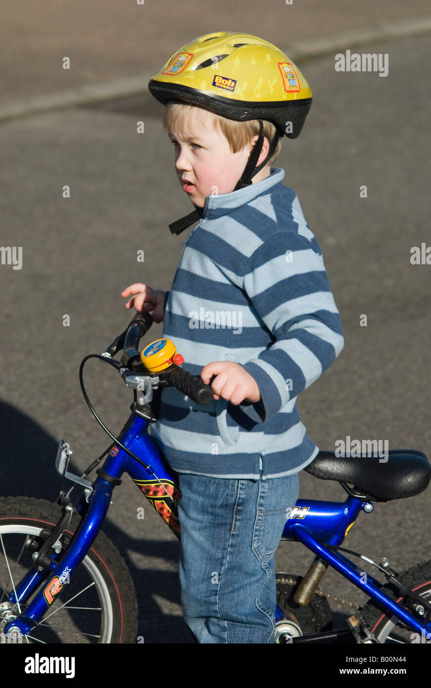 Five year old Boy On Bike in the uk wearing safety helmet Stock Photo Alamy