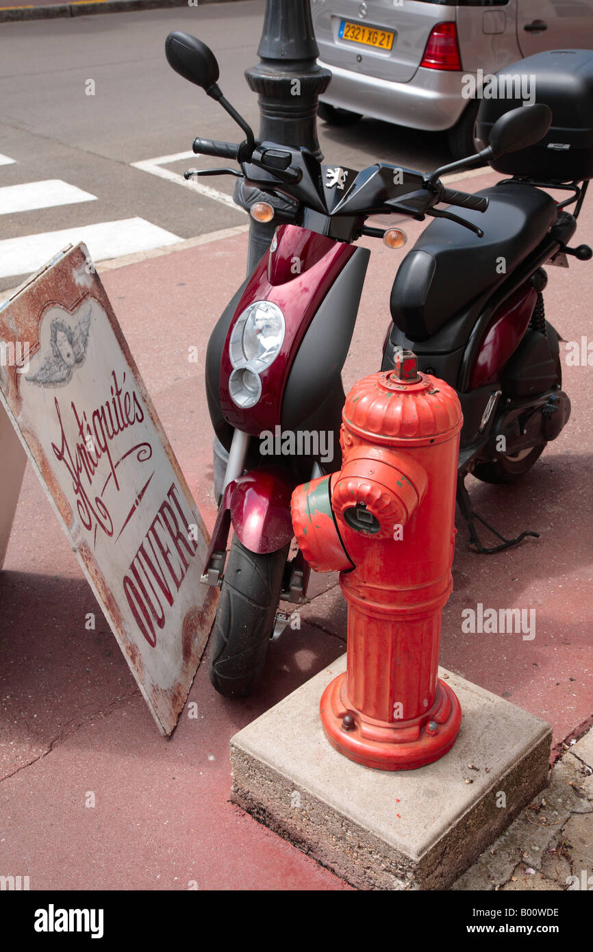 Iconic French street scene with Scooter, Sandwich Board and Fire Hydrant. Stock Photo