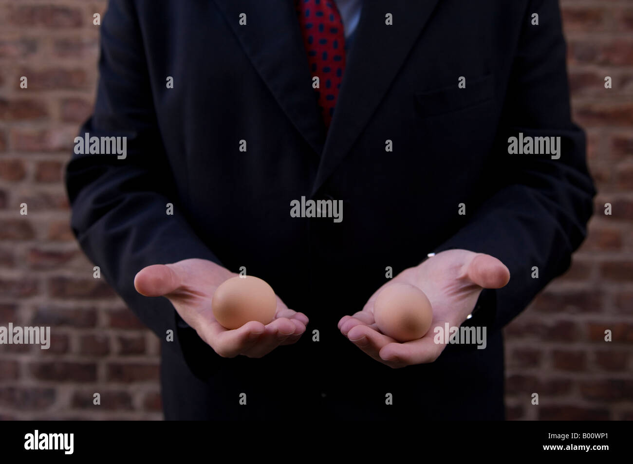 Business man holding eggs Stock Photo