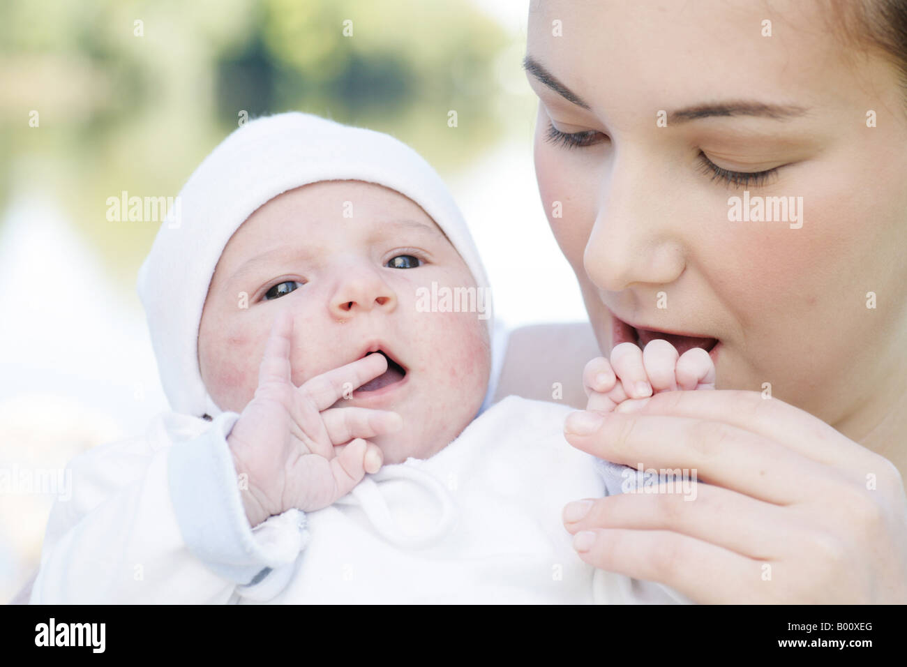Young mother 22 years with six weeks old daughter outdoors Stock Photo