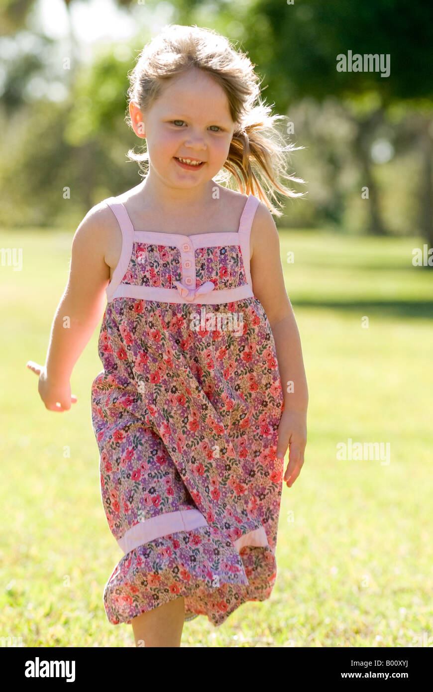 4 year old girls 4 year old girl running in park with happy smile backlighting Stock Photo -  Alamy