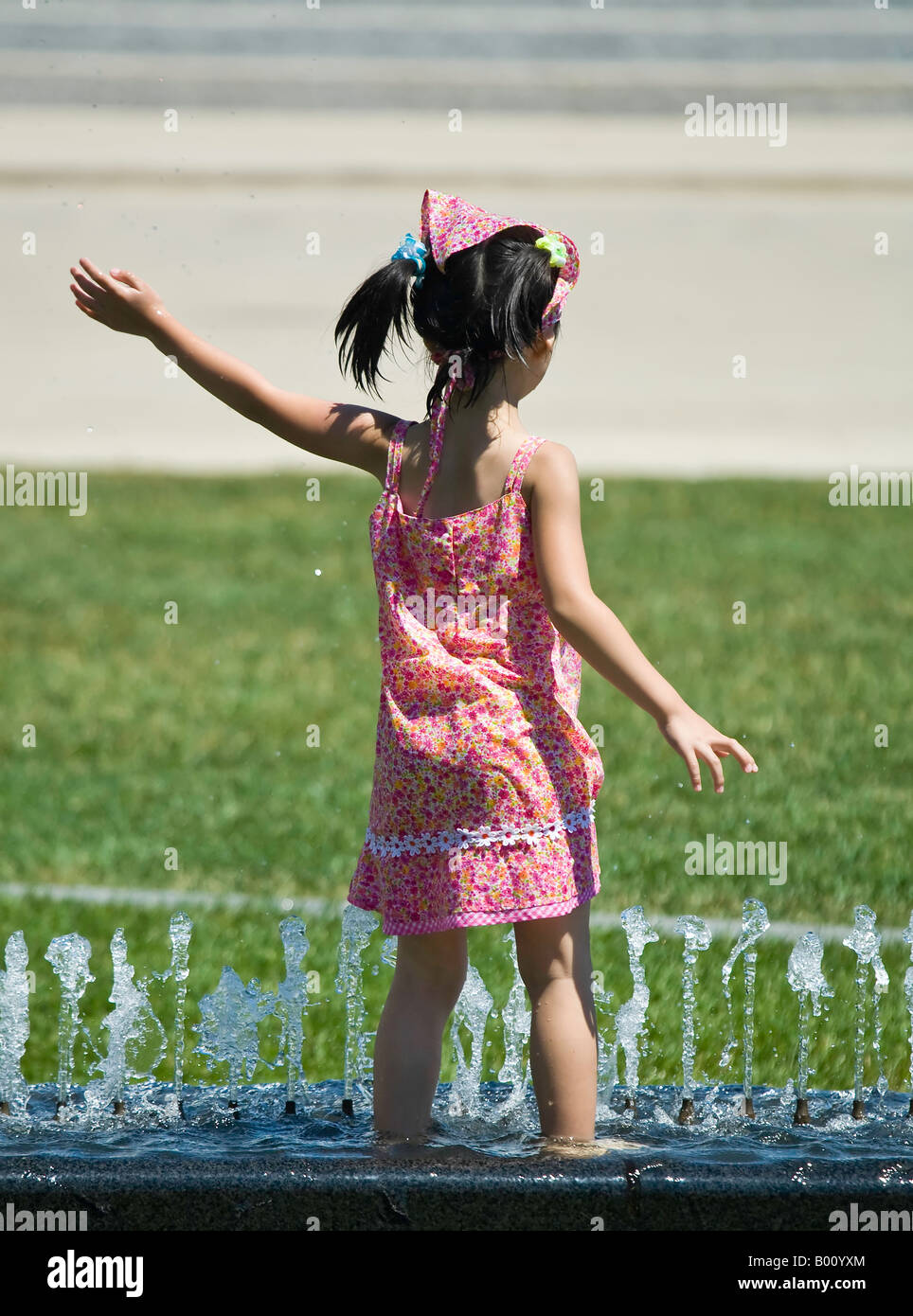 Young Asian girl playing in a fountain Stock Photo - Alamy