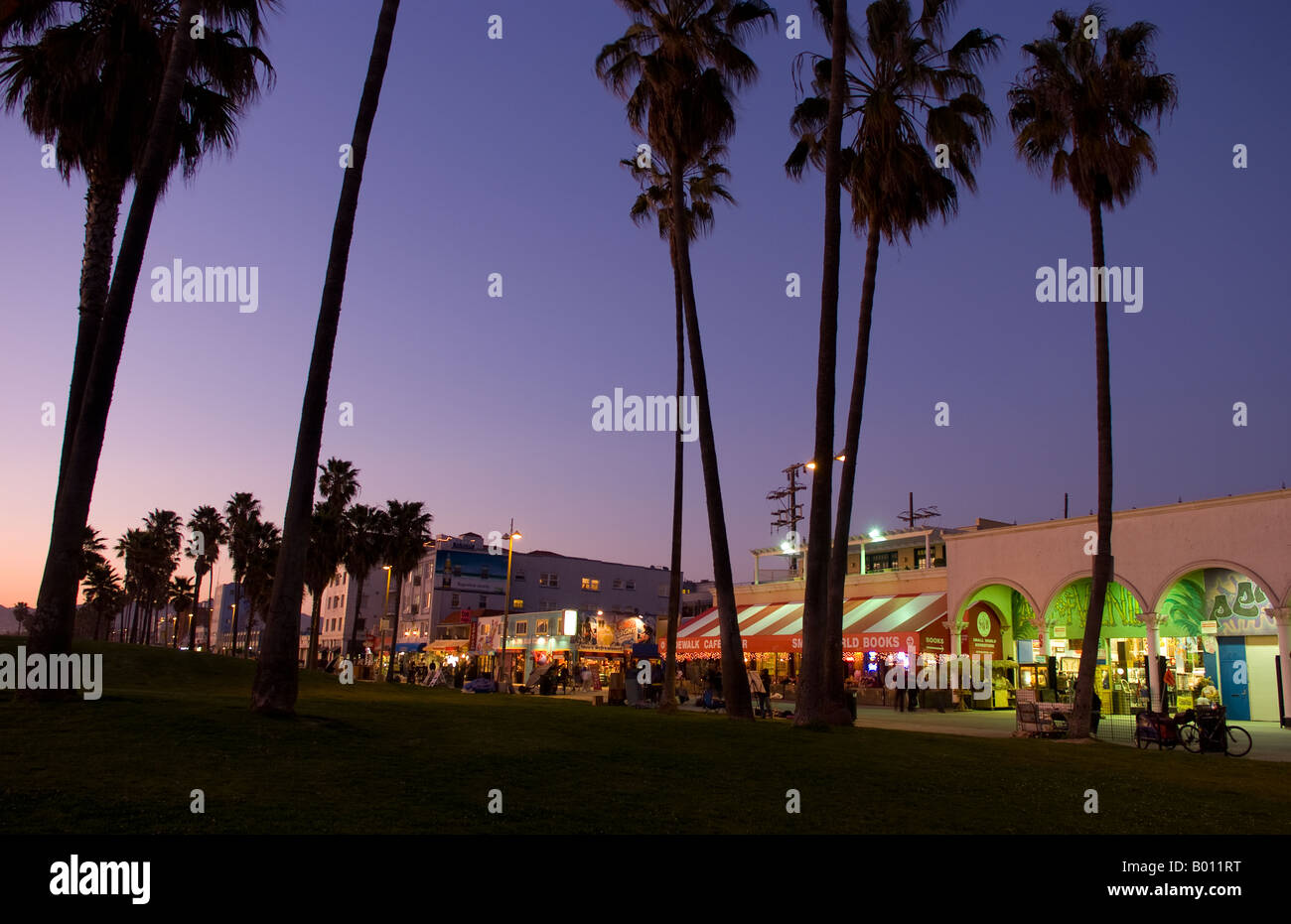 Sunset View With Palm Trees Of Venice Beach California At Night Showing Shops And Nightlife Time Exposure Sunset View With Palm Trees Of Venice Beach California At Night Showing Shops And Nightlife Time Exposure