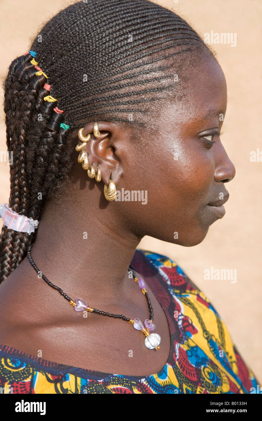 Mali, Douentza. A Bella woman with braided hair wearing gold ear rings in her village near Douentza. Stock Photo
