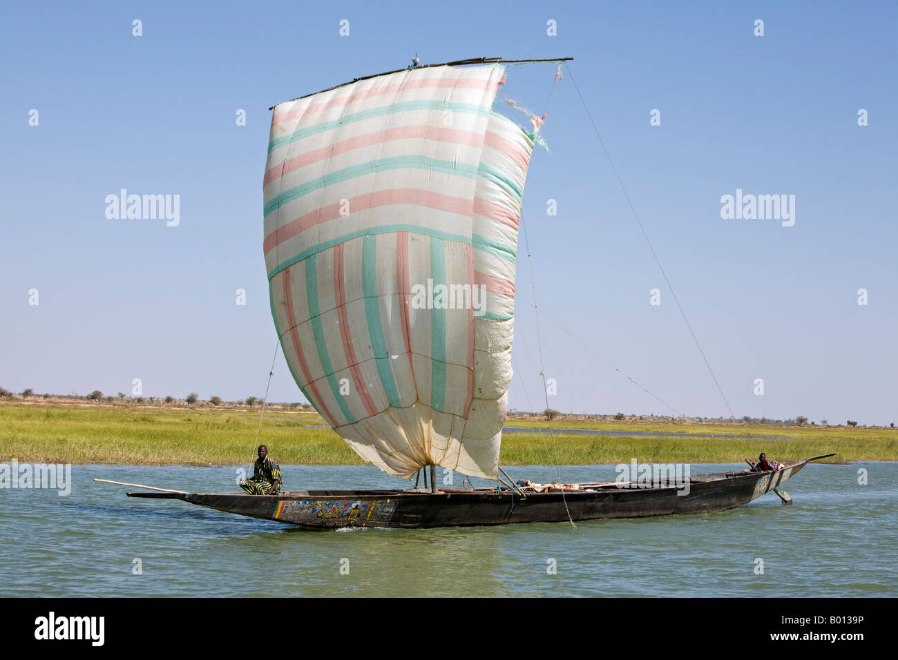 Mali, Niger Inland Delta. A pirogue under sail on the Niger River between Mopti and Timbuktu. Stock Photo