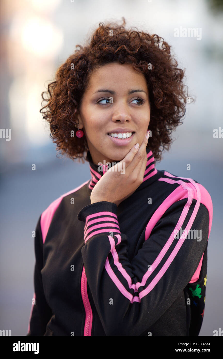 Girl smiling, in sports jacket, ethnic background of model half German half Cuban Stock Photo