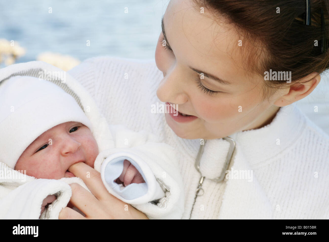 Young mother 22 years with six weeks old daughter outdoors Stock Photo